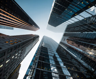 Business and finance concept, looking up at futuristic skyscrapers in the financial district of a modern metropolis.