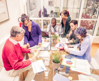 Team of businessmen sharing ideas in a conference meeting - Creative team brainstorming in a modern office